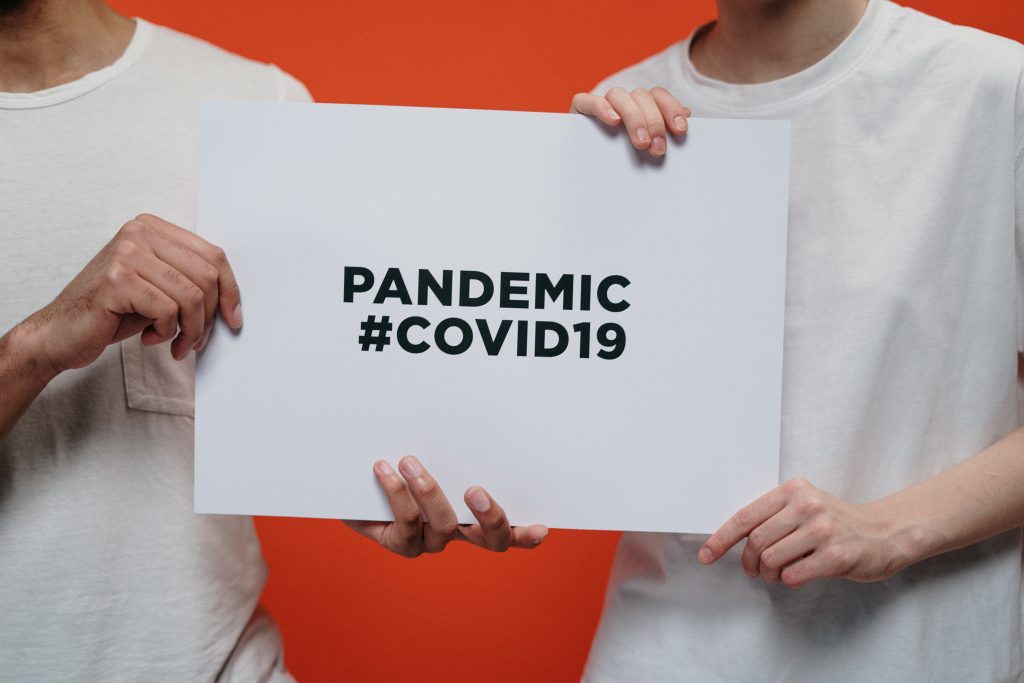 people-holding-white-paper-with-pandemic-covid19-text-3952234-1024x683
